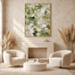 Sage Confetti artwork displayed above a fireplace between cream armchairs.