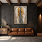 Gilded Wings artwork displayed above a brown leather sofa.