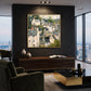 Hillside Gables artwork displayed above a dark console in a city lounge.