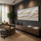 Ivory Tidemarks artwork displayed above a wooden cabinet beside an armchair.