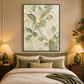 Tender Foliage artwork displayed above a bed with green bedding.