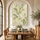 Tender Foliage artwork displayed above a wooden dining table in an arched alcove.