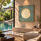 Sage Moonrise artwork displayed above seating beside a poolside window.
