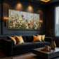 Wildflower Chorus artwork displayed above a dark sofa with gold cushions.