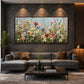 Wildflower Chorus artwork displayed above a gray sofa against a textured wall.