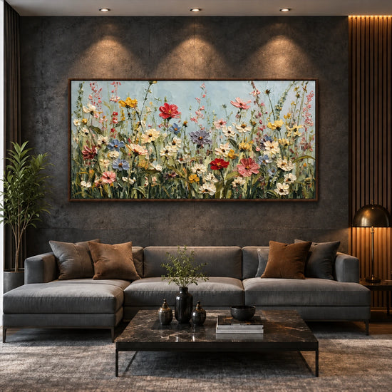 Wildflower Chorus artwork displayed above a gray sofa against a textured wall.