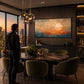 Amber Migration artwork displayed beside a dining table beneath pendant lights.