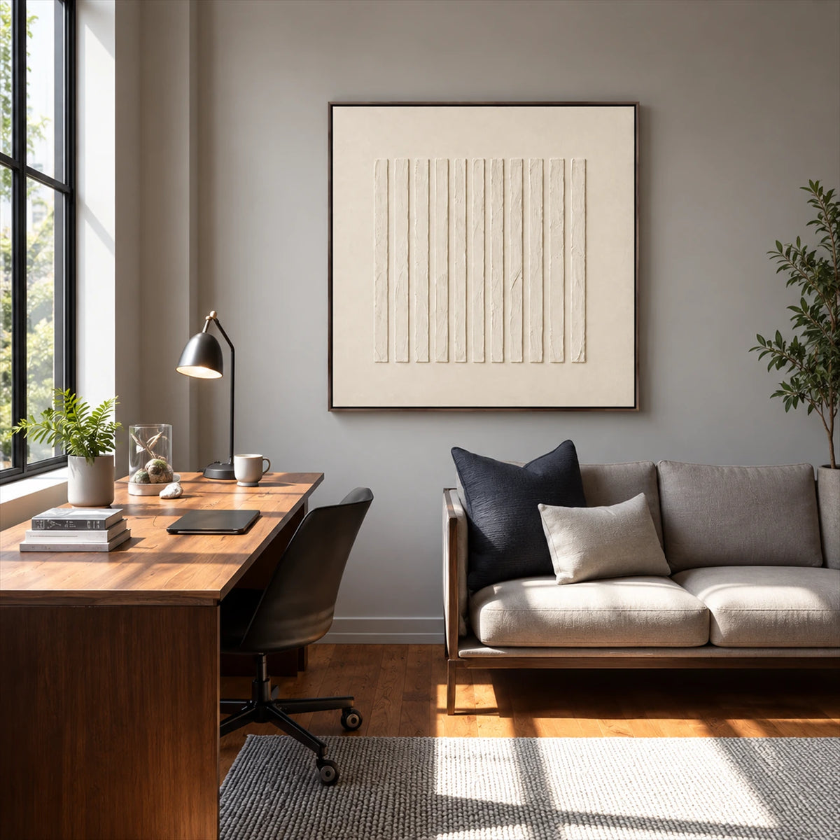 Quiet Fluting artwork displayed above a gray sofa beside a desk.