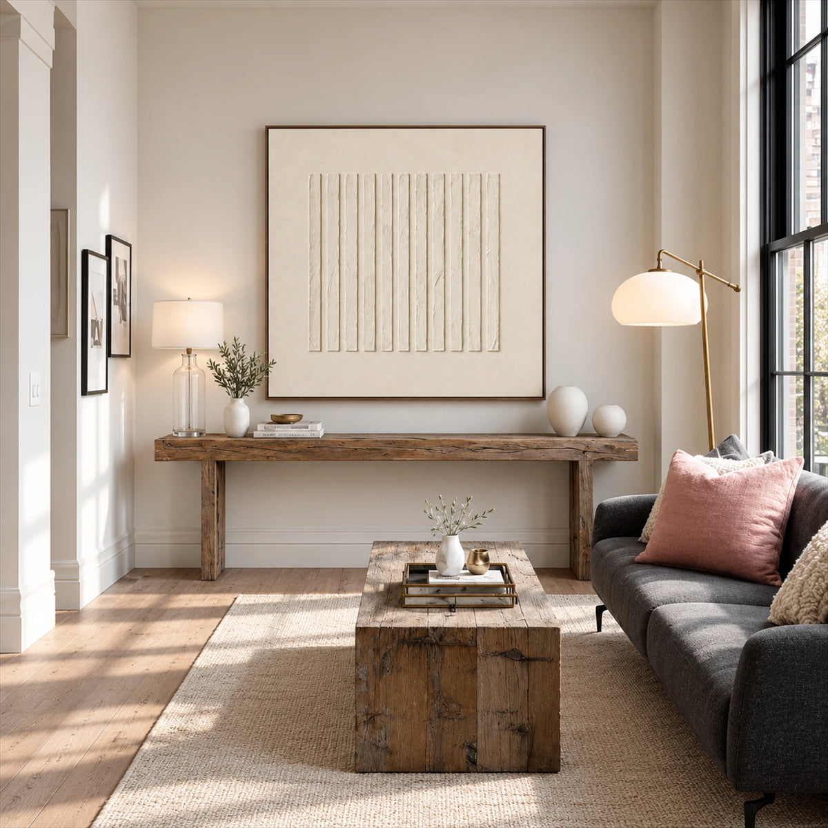 Quiet Fluting artwork displayed above a wooden console behind lounge seating.