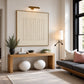 Quiet Fluting artwork displayed above a wooden console and decorative spheres.