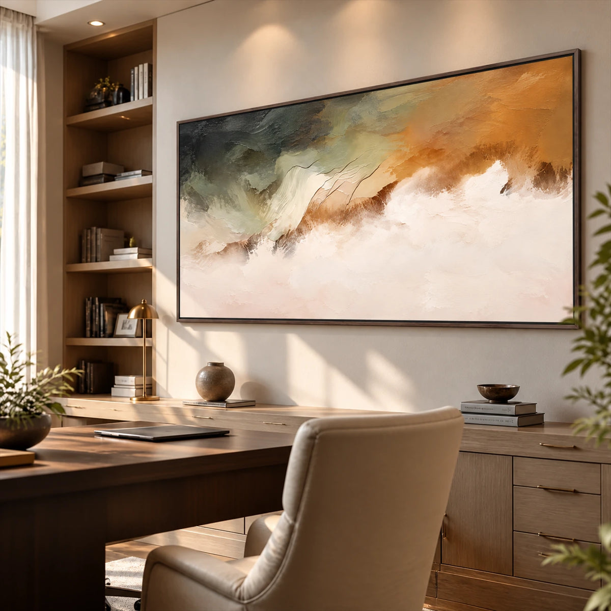 Ochre Mistfall artwork displayed above a desk beside bookshelves.