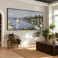 Hydrangea Harbor artwork displayed above woven chairs near a bright window.
