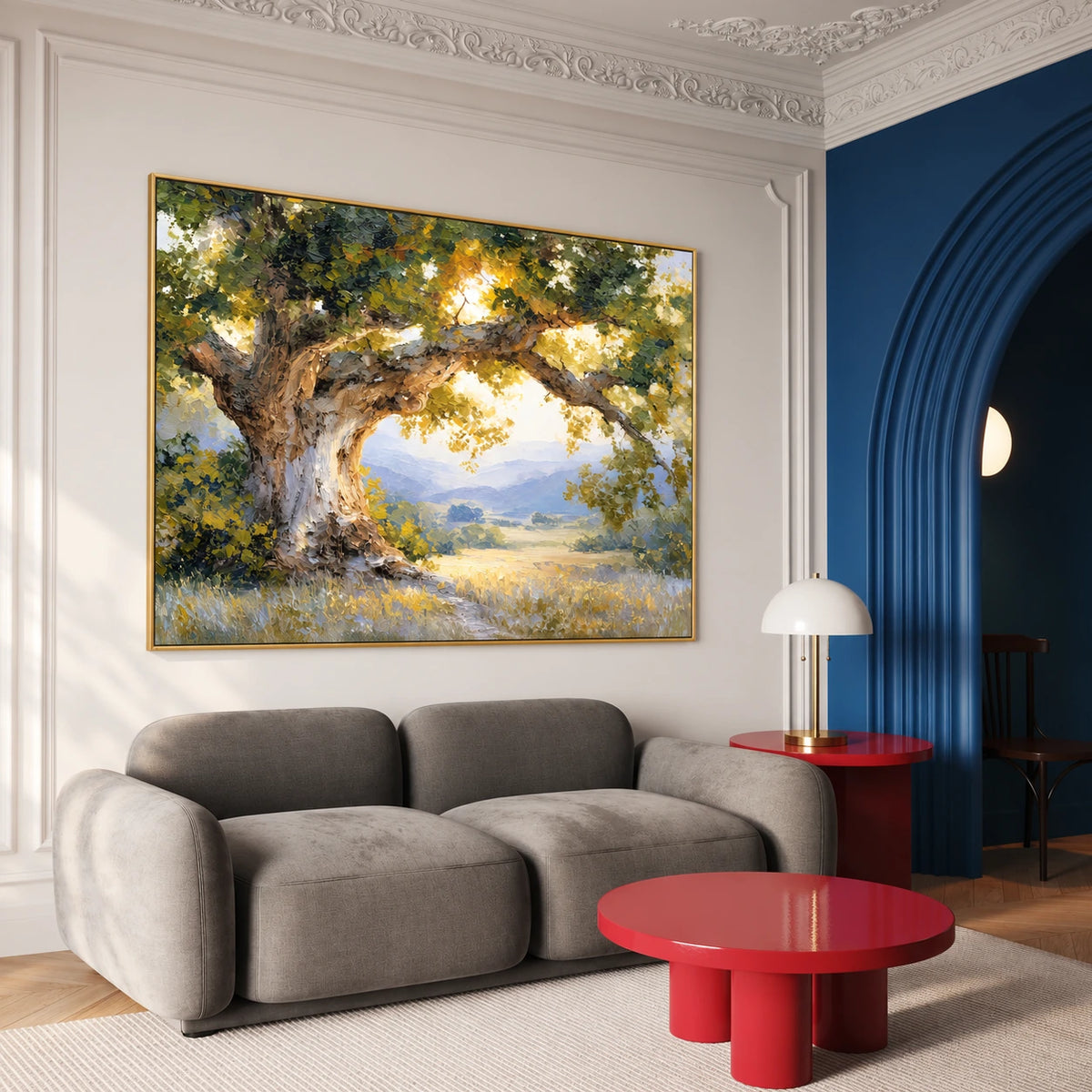 Sunlit Oak artwork displayed above a gray sofa beside red tables.