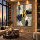 Gilded Junction artwork displayed above neutral lounge seating beside a window.