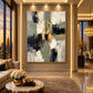Gilded Junction artwork displayed beside a sofa overlooking city windows.