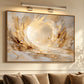 Luminous Hollow artwork displayed above a neutral sofa beneath picture lights.