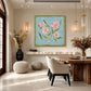 Blush Sprigs artwork displayed above a console near a dining area.
