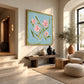 Blush Sprigs artwork displayed above a wooden bench beside an arched window.