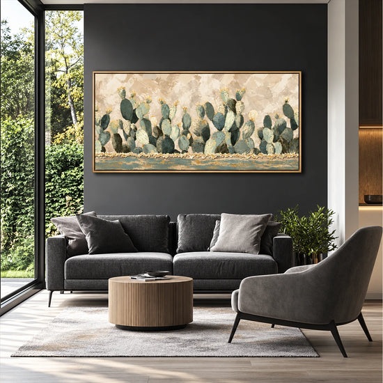 Sage Cactus Row artwork displayed above a dark sofa by tall windows.