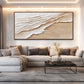 Sandy Tides artwork displayed above a gray sofa and dark coffee table.