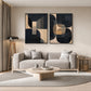 Noir Geometry two-panel artwork set displayed above a pale sofa and round coffee table.