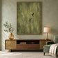 Olive Hover artwork displayed above a two-tone wooden sideboard beside green seating.