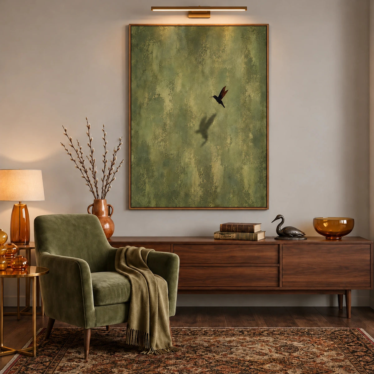 Olive Hover artwork displayed above a long wooden sideboard beneath a picture light.