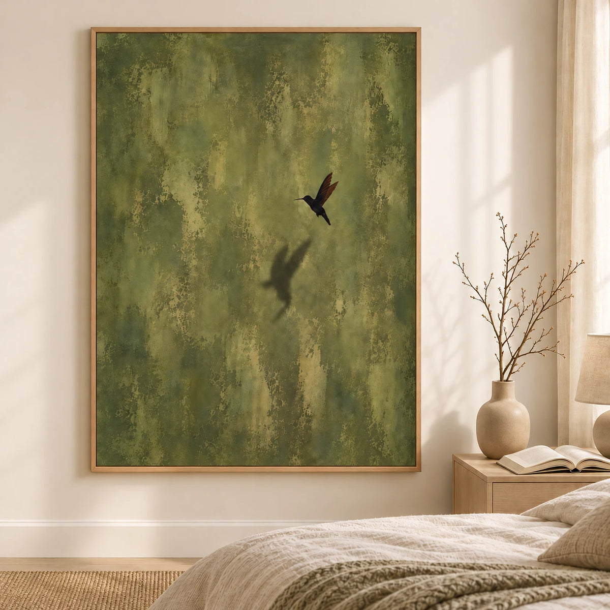 Olive Hover artwork displayed beside a bed and wooden bedside table.