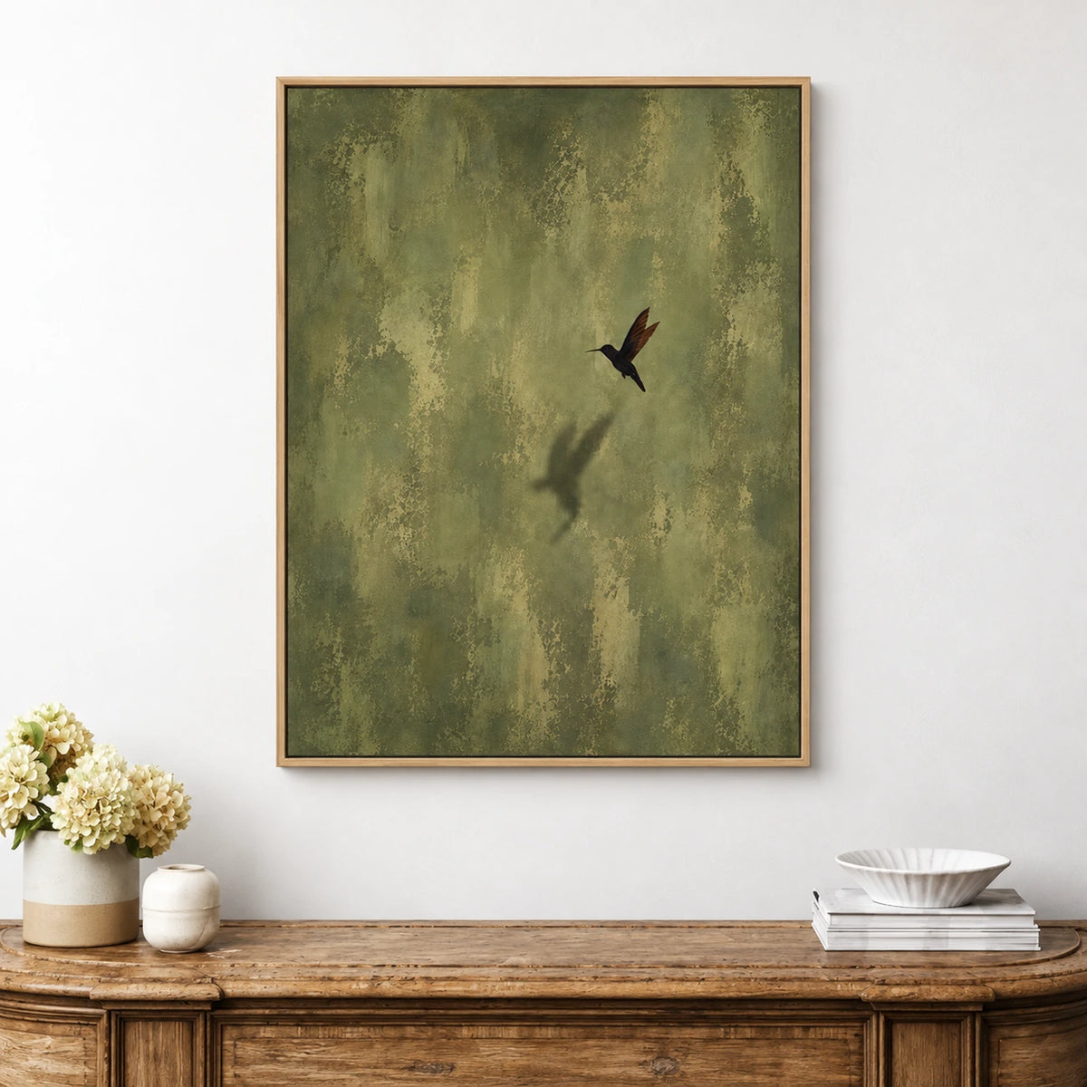 Olive Hover artwork displayed above a rustic wooden console in a bright room.