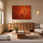 Ember Hover artwork displayed above a wooden sideboard beside lounge seating.