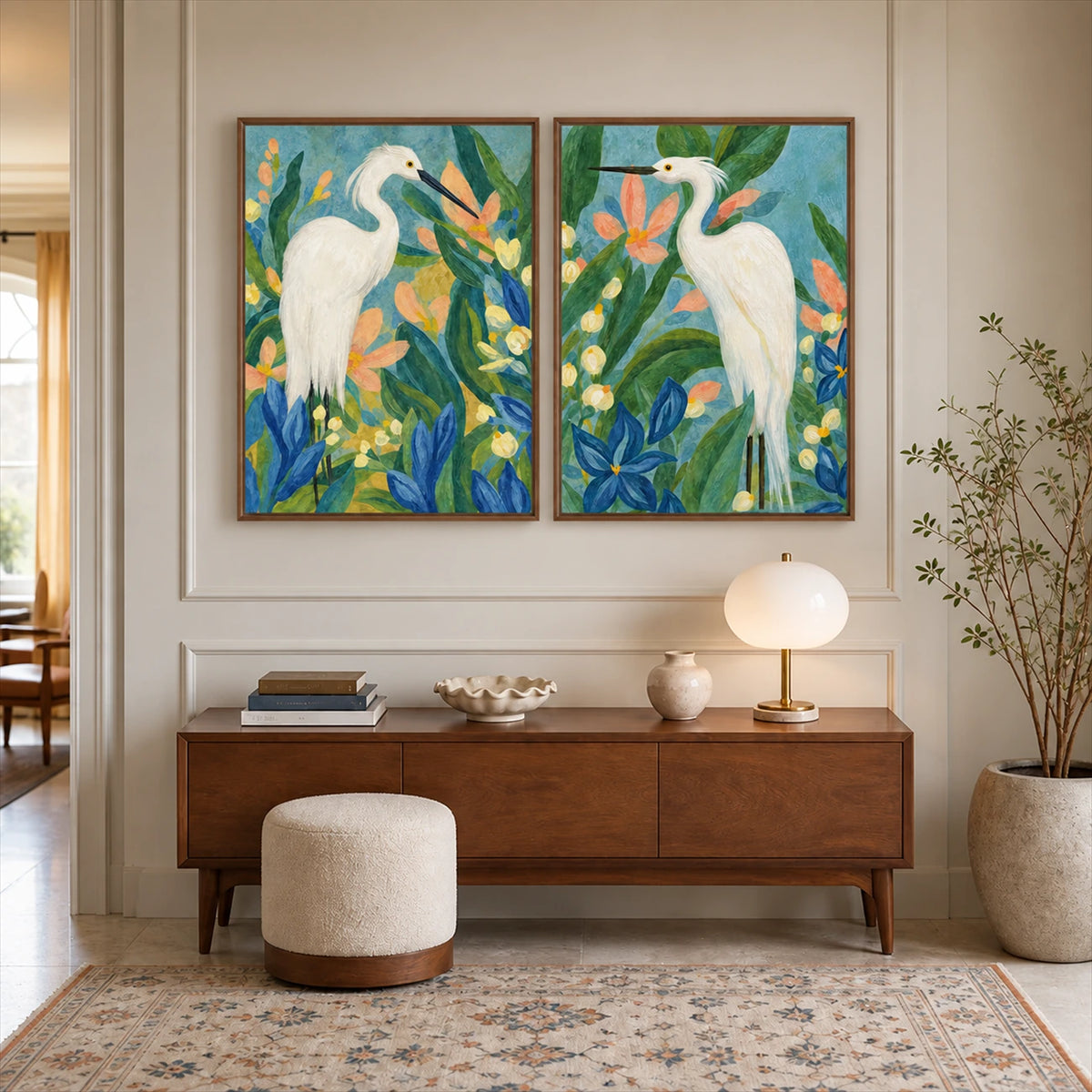 Heron Garden two-panel artwork set displayed above a wooden sideboard with a glowing table lamp.