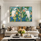 Heron Garden two-panel artwork set displayed above a tufted sofa in a paneled living room.