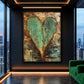 Patina Heart artwork displayed on a dark wall beside green seating.