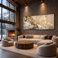 Gilded Confluence artwork displayed above a sectional sofa near a stone fireplace.