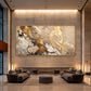 Gilded Confluence artwork displayed above lounge seating beneath a tall illuminated wall.