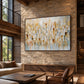 Gilded Fragments artwork displayed above neutral seating on a stone wall.