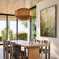 Meadow Haze artwork displayed beside a dining table and geometric pendant light.
