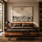 Distant Pasture artwork displayed above a leather bed beside a window.