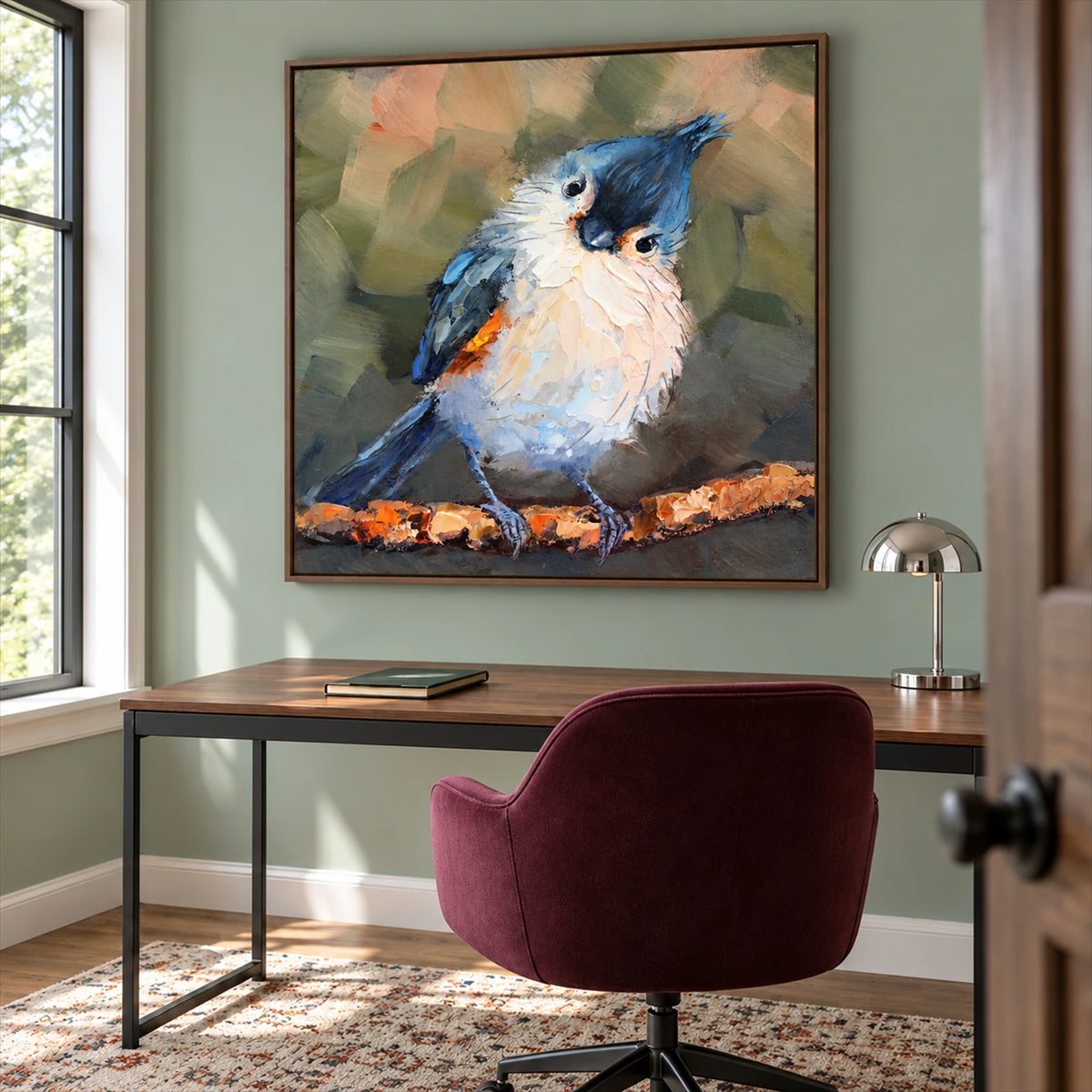 Curious Crest artwork displayed above a desk beside a burgundy chair.