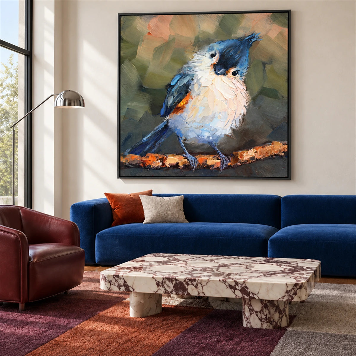 Curious Crest artwork displayed above a blue sofa and marble coffee table.