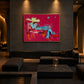 Turquoise Reverie artwork displayed above a black sectional sofa beneath recessed lighting.