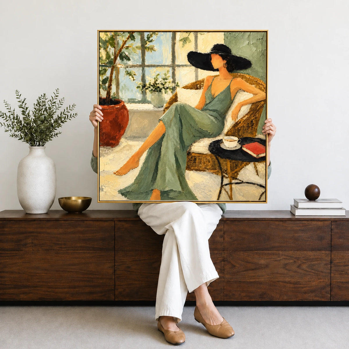 Sage Siesta artwork displayed held in front of a person seated on a wood console.