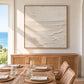 Quiet Foreshore artwork displayed above a wood sideboard beside a dining table.