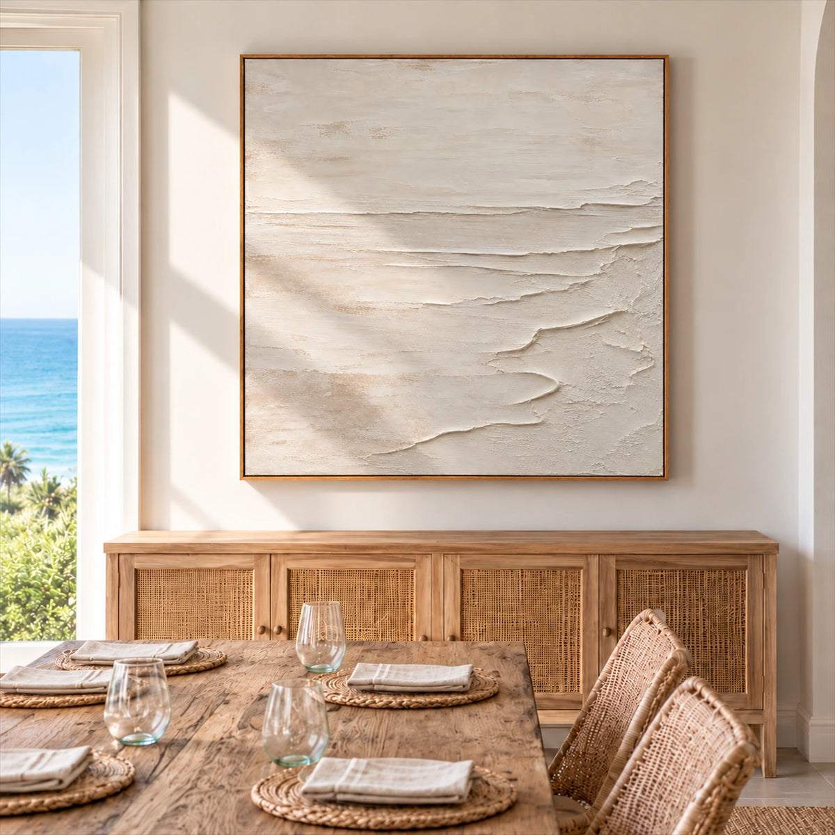 Quiet Foreshore artwork displayed above a wood sideboard beside a dining table.