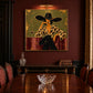 Leopard Reverie artwork displayed above a dining table beneath a picture light.