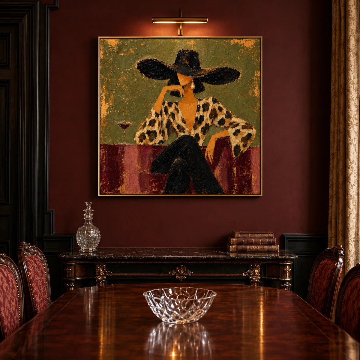 Leopard Reverie artwork displayed above a dining table beneath a picture light.