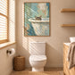 Bathside Peek artwork displayed above a toilet beside a wood vanity.