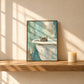 Bathside Peek artwork displayed leaning on a wood shelf beside a candle.