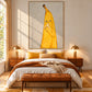 Banana Break artwork displayed above a bed with yellow cushions and warm lighting.