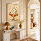Alpine Aperitif artwork displayed above a marble console in an arched hallway.